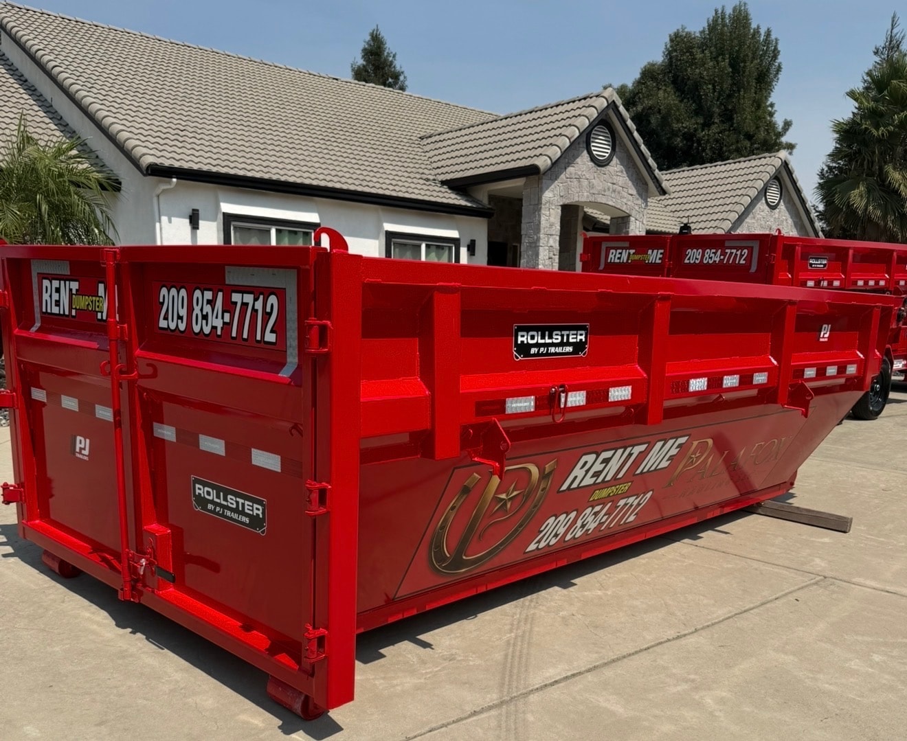 Palafox Hauling LLC red roll-off dumpster trailer ready for rental